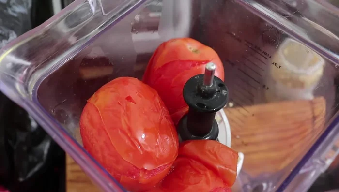 Add the reserved pasta water to the blender to help blend the ingredients.