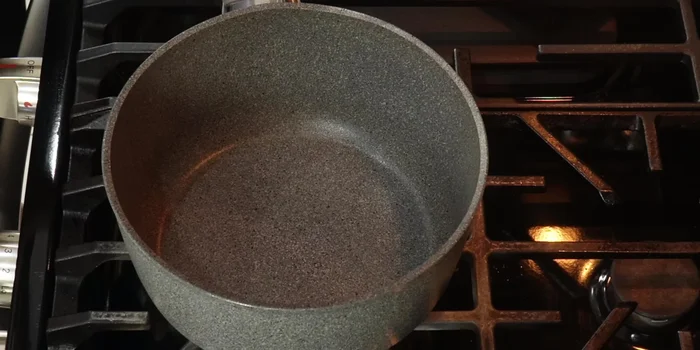 In a pot, dissolve the piloncillo in water over medium heat.