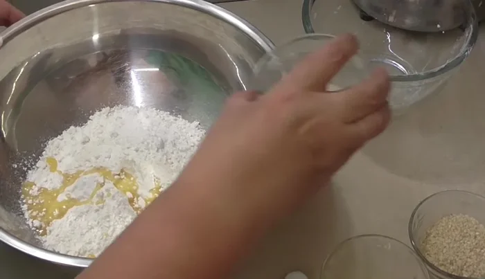 Combine remaining ingredients: Add remaining flour, melted (or room temperature) butter, sugar, salt, and one egg to the activated yeast mixture. Knead for 15-20 minutes until smooth and elastic. (Can be done in a bowl or on a floured surface).