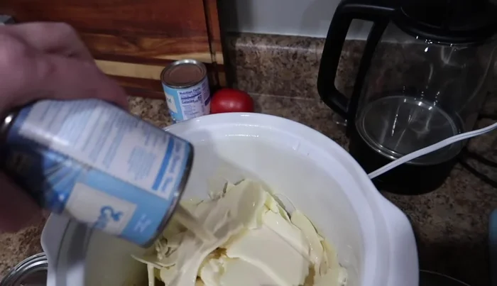 Add two cans of evaporated milk to the crockpot.