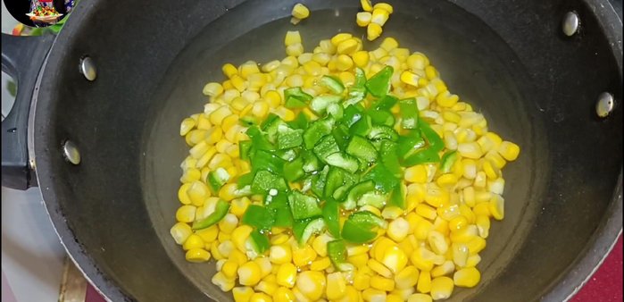Cut the capsicum and carrot into cubes and add them to the boiling sweet corn. Add sausages.