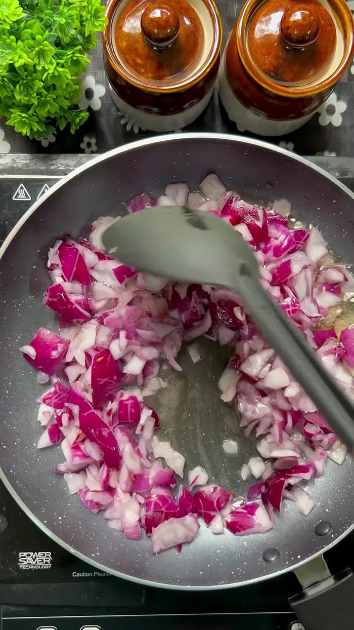 Add chopped onions, tomatoes, capsicum, and other vegetables along with garlic and green chilies. Saute for a few minutes.