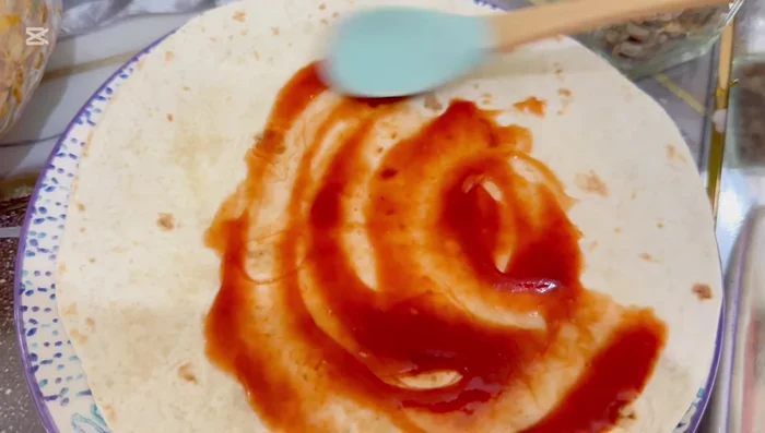 Fold the tortilla wrap and lightly brown it on a pan until the cheese is melted.