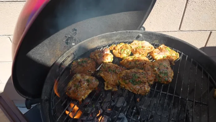 Once seared, move chicken thighs to the indirect heat zone. Continue cooking, monitoring the internal temperature.