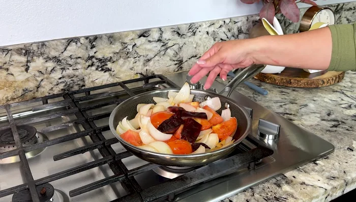 Add 2 Chile guajillo, 1 Chile ancho, 1 chipotle pepper, adobo sauce, 2 1/2 tablespoons shrimp bouillon, 1/2 tablespoon oregano, and 2 cups boiling water. Cover and cook for 5 minutes.