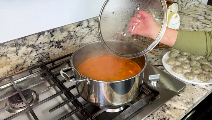 Bring to a boil. Once boiling, slowly add the shrimp meatballs to avoid burning.