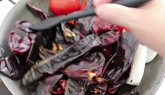 Add ground or 3-4 cloves of garlic (if using fresh garlic). Fry until the chilies change color.