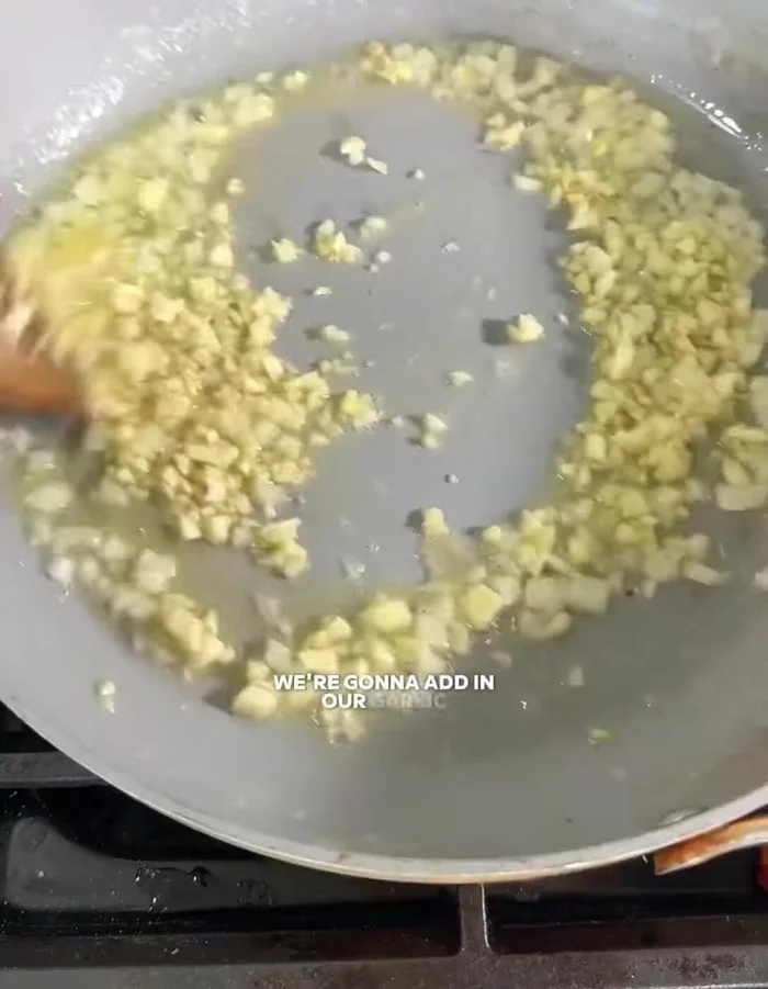 Add minced garlic, guajillo pepper, and chili flakes to the pan. Cook until fragrant.