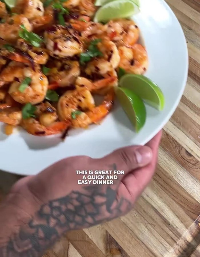 Plate the shrimp, garnish with cilantro, and serve with lime wedges.
