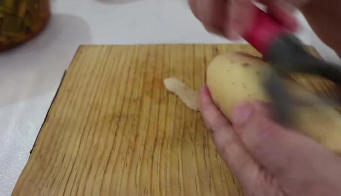 Peel and cut potatoes into small pieces.