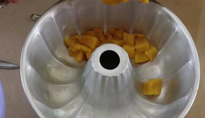 Layer the gelatin: Layer half of the cubed mangoes in the prepared mold. Pour in the milk mixture. Refrigerate until partially set.