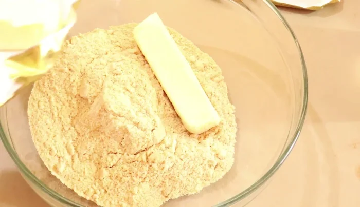 Mix crushed cookies with softened butter.