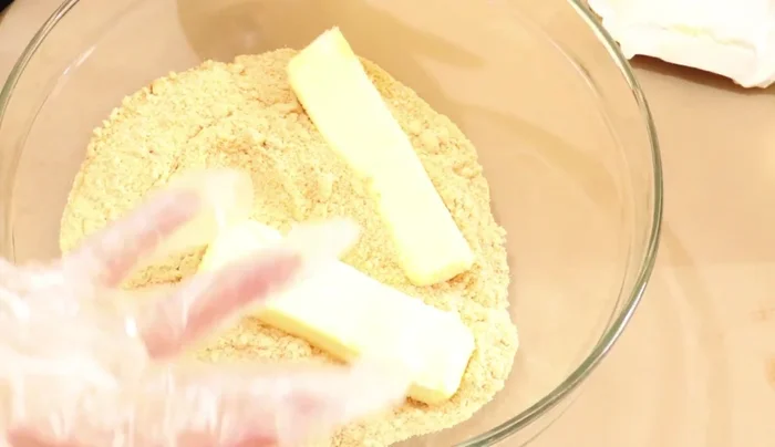 Press cookie mixture into the bottom and up the sides of a plastic-lined pie mold. Freeze for at least 30 minutes.