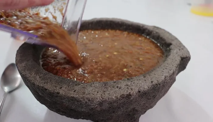 Transfer the salsa to a bowl or mortar.