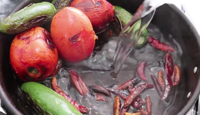Add water to the fried chiles and bring to a boil to hydrate them.