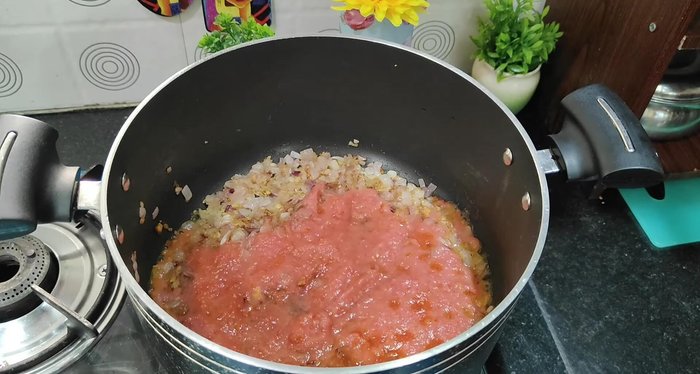 Add tomato puree, salt, cumin powder, coriander powder, Kashmiri red chili powder, oregano, red chili flakes, and tomato ketchup. Mix well and cook for 3 minutes.