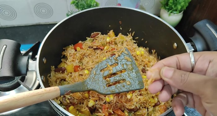 Gently fluff the rice with a fork. Garnish with green coriander.