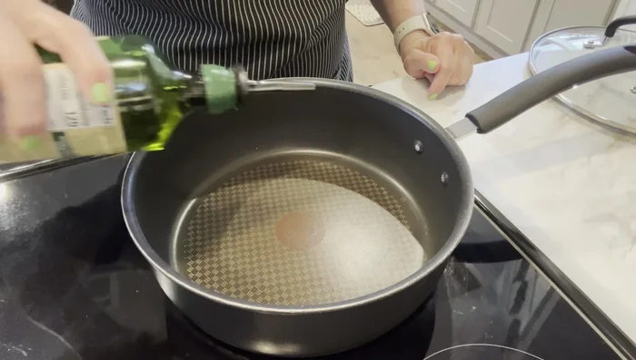Heat 2 tablespoons of olive oil in a skillet over medium heat.