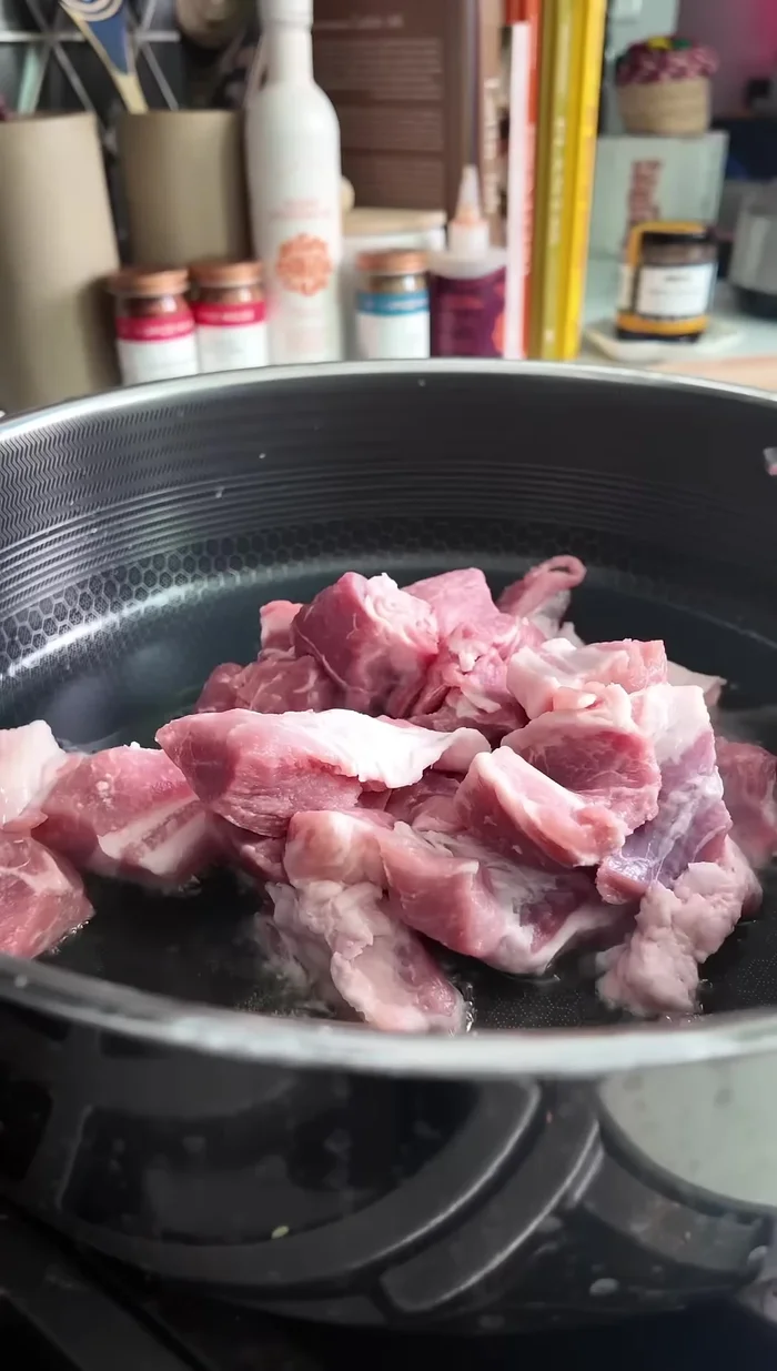 Add avocado oil to a big skillet. Add the pork and spread it out in an even layer.
