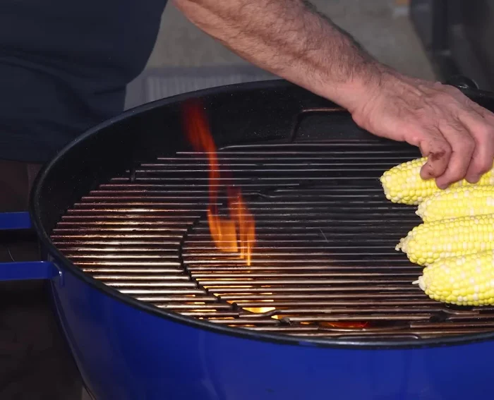 Grill the corn (on the cob): Place corn (husked and unhusked) directly on the hot coals. Rotate occasionally for even cooking. Husked corn will cook faster (15 mins), unhusked will take longer (25-30 mins).