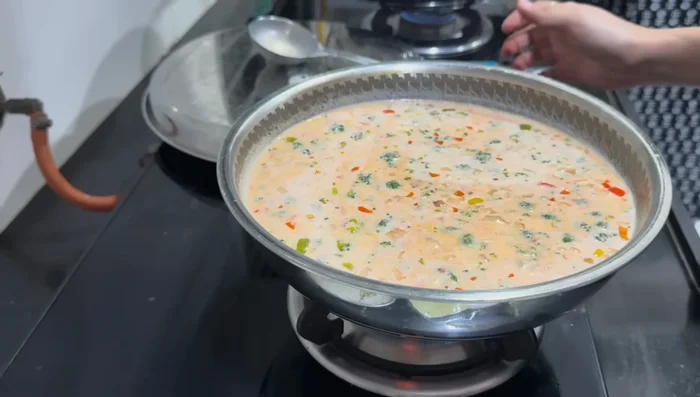 Add milk and bring to a boil. Add cheese slices.