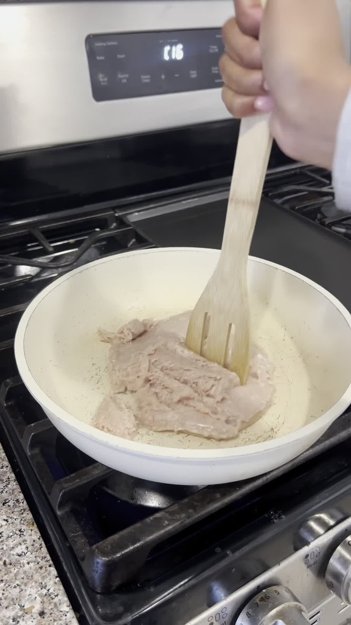 Season the mashed turkey with cumin, taco seasoning, paprika, a dash of water, and a little bit of Accent seasoning to taste.