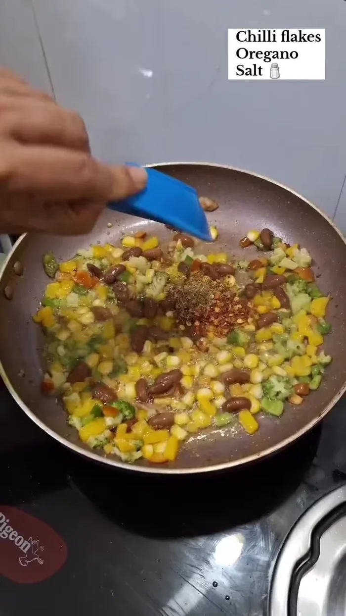 Add chili flakes, oregano, and salt to taste. Mix well.