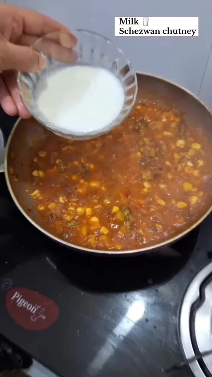 Add milk and Schezwan chutney. Mix well.