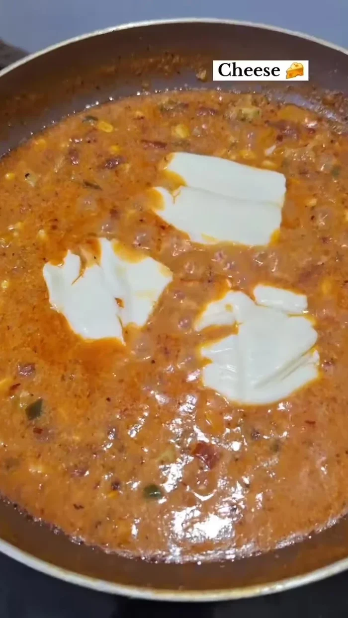 Add cheese slices and mix well. Add green coriander on top. The creamy gravy is ready.