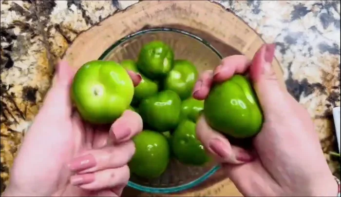 Prepare the green salsa: Remove the husks from the tomatillos and rinse them well until there's no stickiness. Add tomatillos, jalapenos, onion, and water to a pot and cook for 5 minutes, or until tomatillos change color.