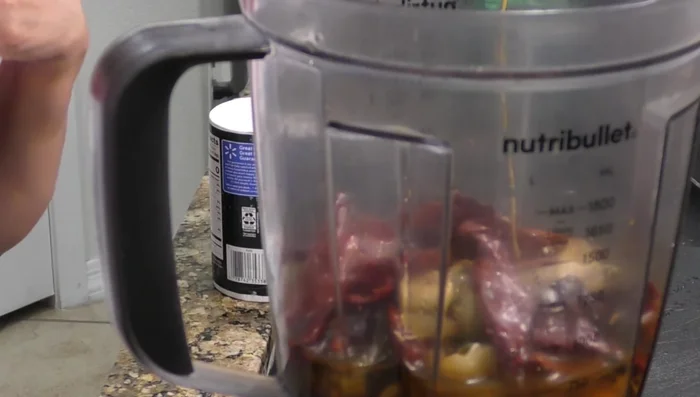 Blend the cooked chiles, garlic, onion, apple cider vinegar, and salt until smooth. (237.28)