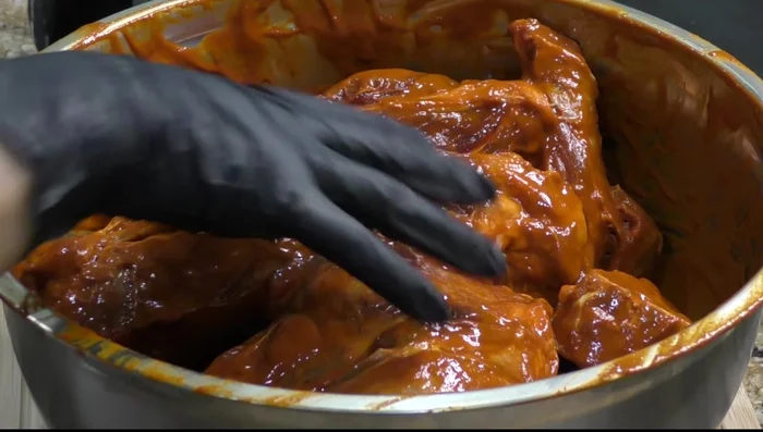 Coat the goat leg generously with the sauce, massaging it in to ensure even distribution. Refrigerate for at least 3 hours, or overnight. (266.919)