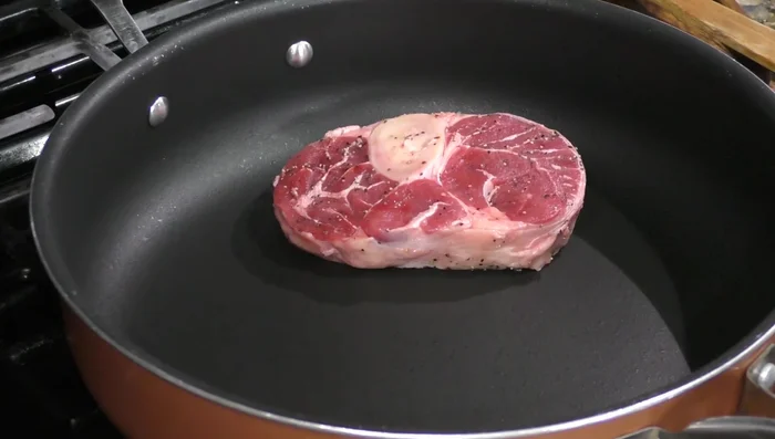 Sear the meat in the pot until it is browned on all sides.