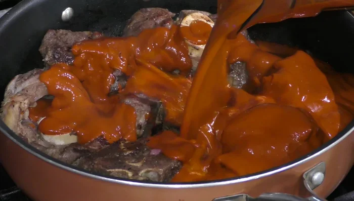 Add a cup of water to deglaze the pan, scraping up any browned bits.
