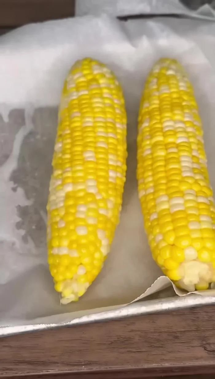 Remove the corn from the water and place it on a baking sheet or pan.