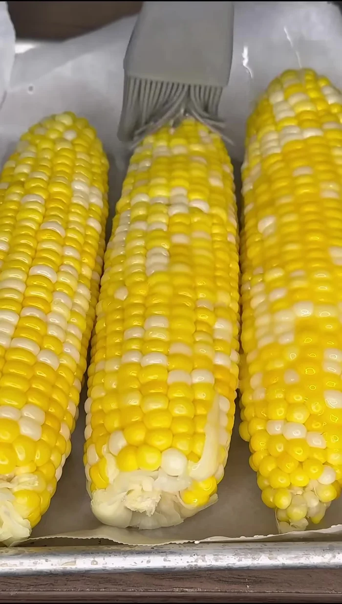 Spread melted butter over the corn.