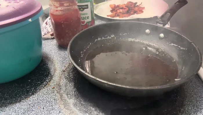 In the same skillet, sauté the chopped onion in the reserved bacon grease until softened.