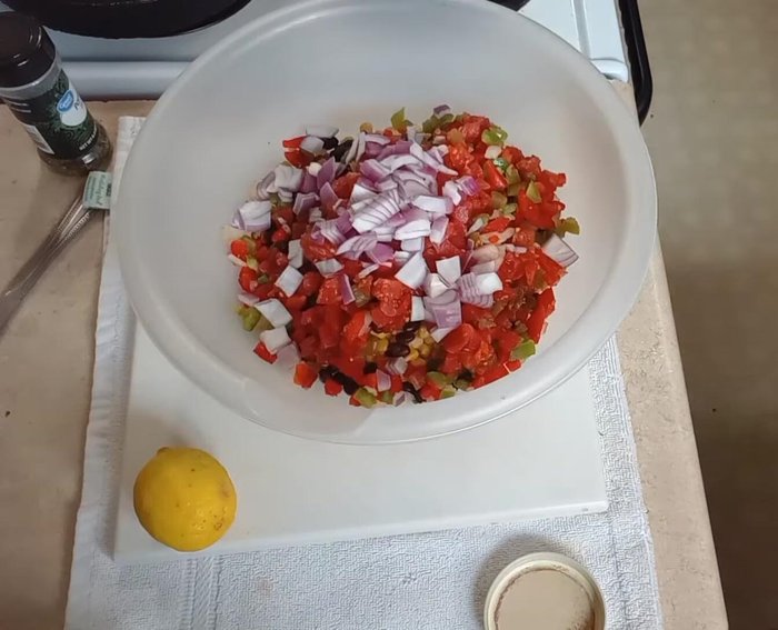 Add the corn, black beans, Rotel, bell peppers, and red onion to a mixing bowl.