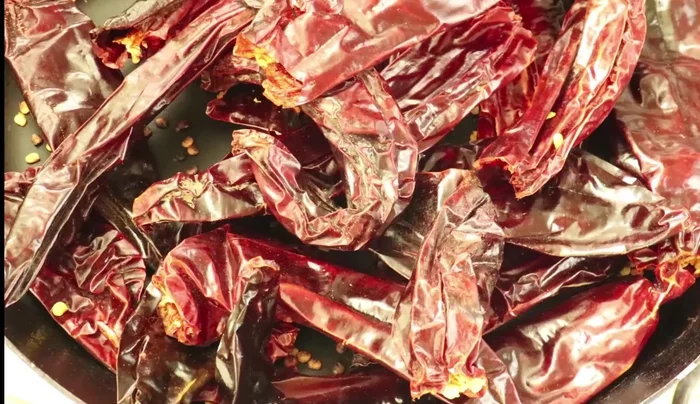Soak the roasted chilies in hot water for a few minutes.