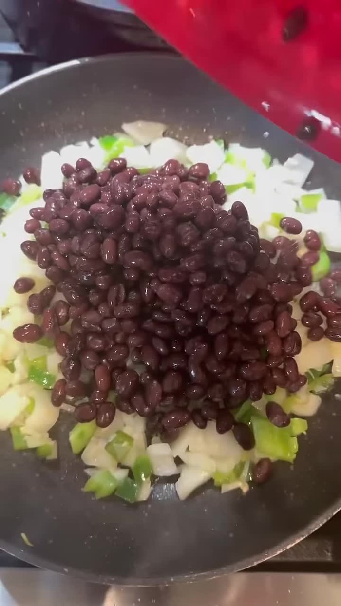 Add canned black beans and taco seasoning.