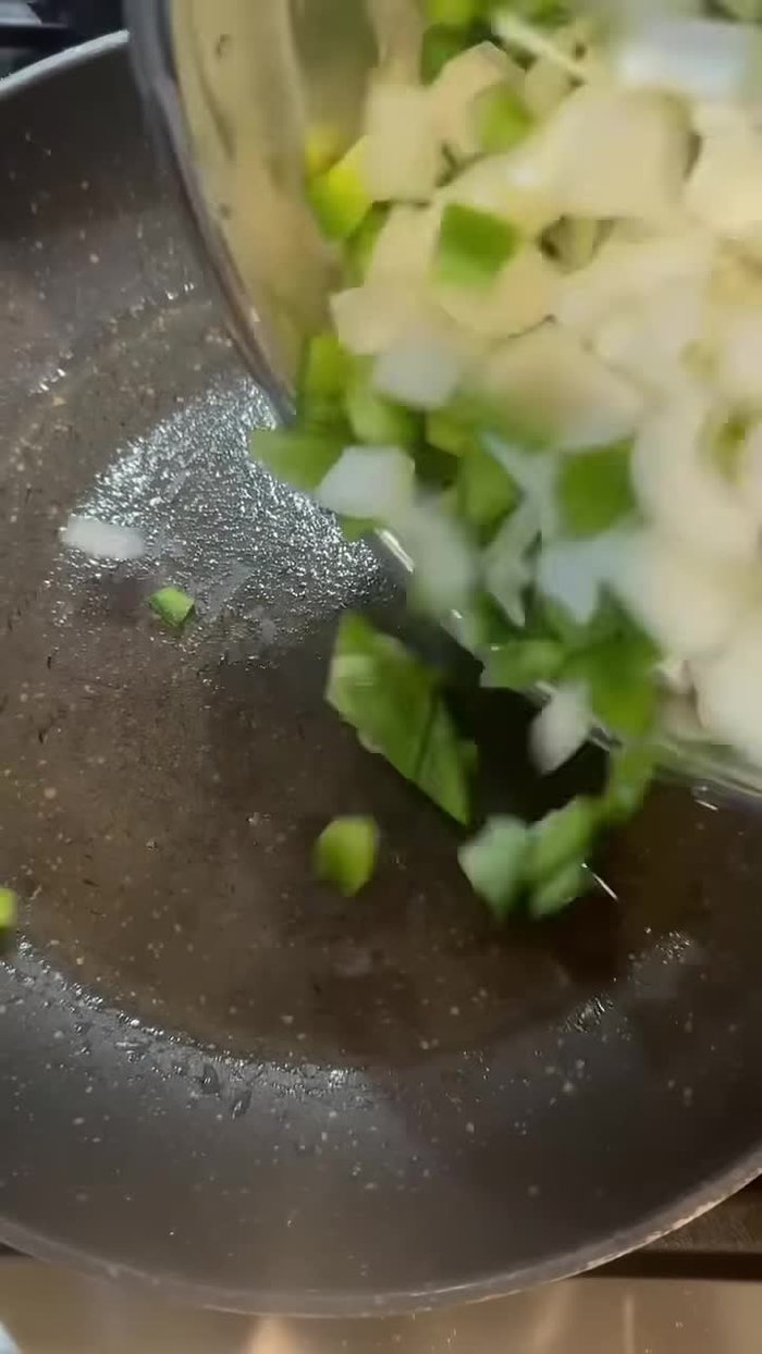 Cook down bell pepper, onion, and jalapeno in a skillet.