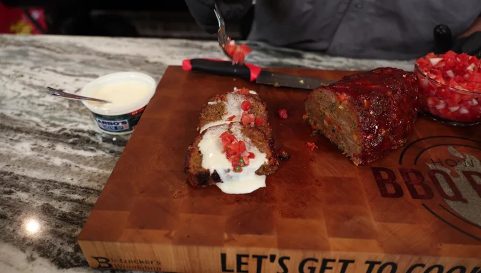 Serve the sliced meatloaf topped with warmed queso, fresh pico de gallo, and cilantro.