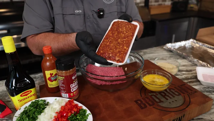 Combine 1 pound of ground beef and 1 pound of chorizo sausage in a bowl.