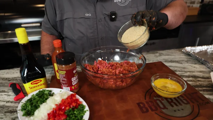 Add breadcrumbs, 2 eggs, 1 whole jalapeno, diced red bell pepper, diced white onion, and cilantro. Mix well.