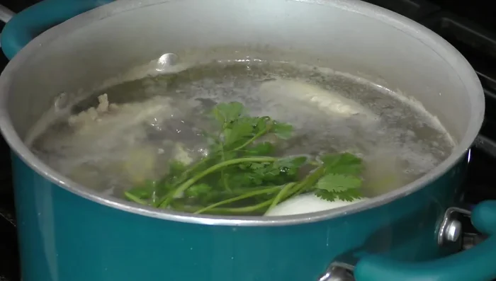 Add onion, cilantro, garlic, and salt to the pot and cook the chicken for about 30 minutes.