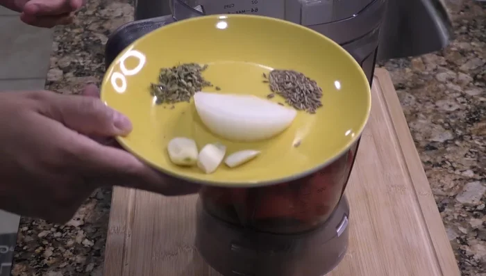 Blend the tomatoes, garlic, cumin, oregano, and onion.