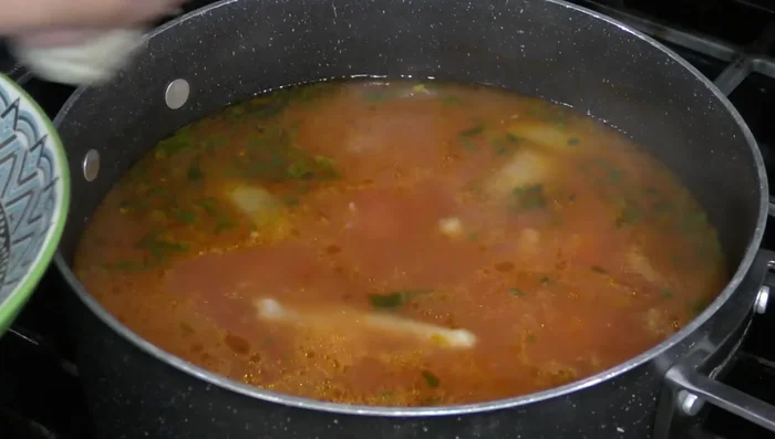 Add the cooked chicken, zucchini, and chopped cilantro to the soup. Season with salt to taste.