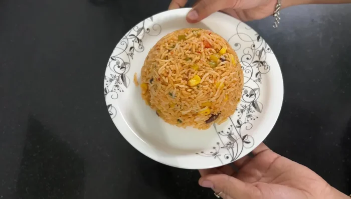 To plate: Arrange the rice in a bowl. Top with the spicy gravy and cheese (optional). Garnish with coriander.