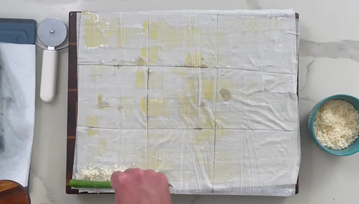 Wrap each asparagus spear in a phyllo rectangle with parmesan and salt. Seal with butter.