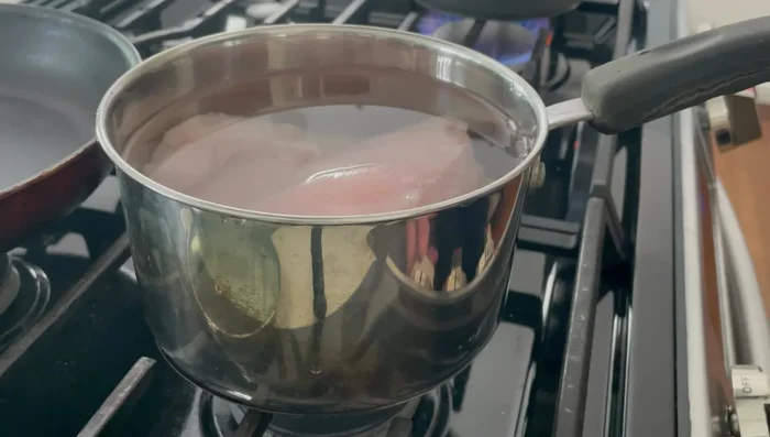 Boil chicken breasts in water with salt until cooked (8-10 minutes). Skim off any scum.